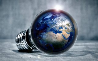A light bulb laying on its side with the main part of the bulb looking like a globe.