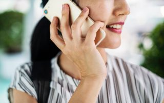 Image of a woman on the phone. Photo by rawpixel on Unsplash.