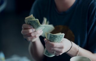Woman counting dollar bills