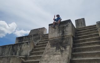 A young man (new JVA associate consultant Jessi Rodriguez) sits at the top of Mayan ruins.