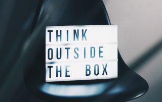 Chair with a sign on it that says "Think outside the box"